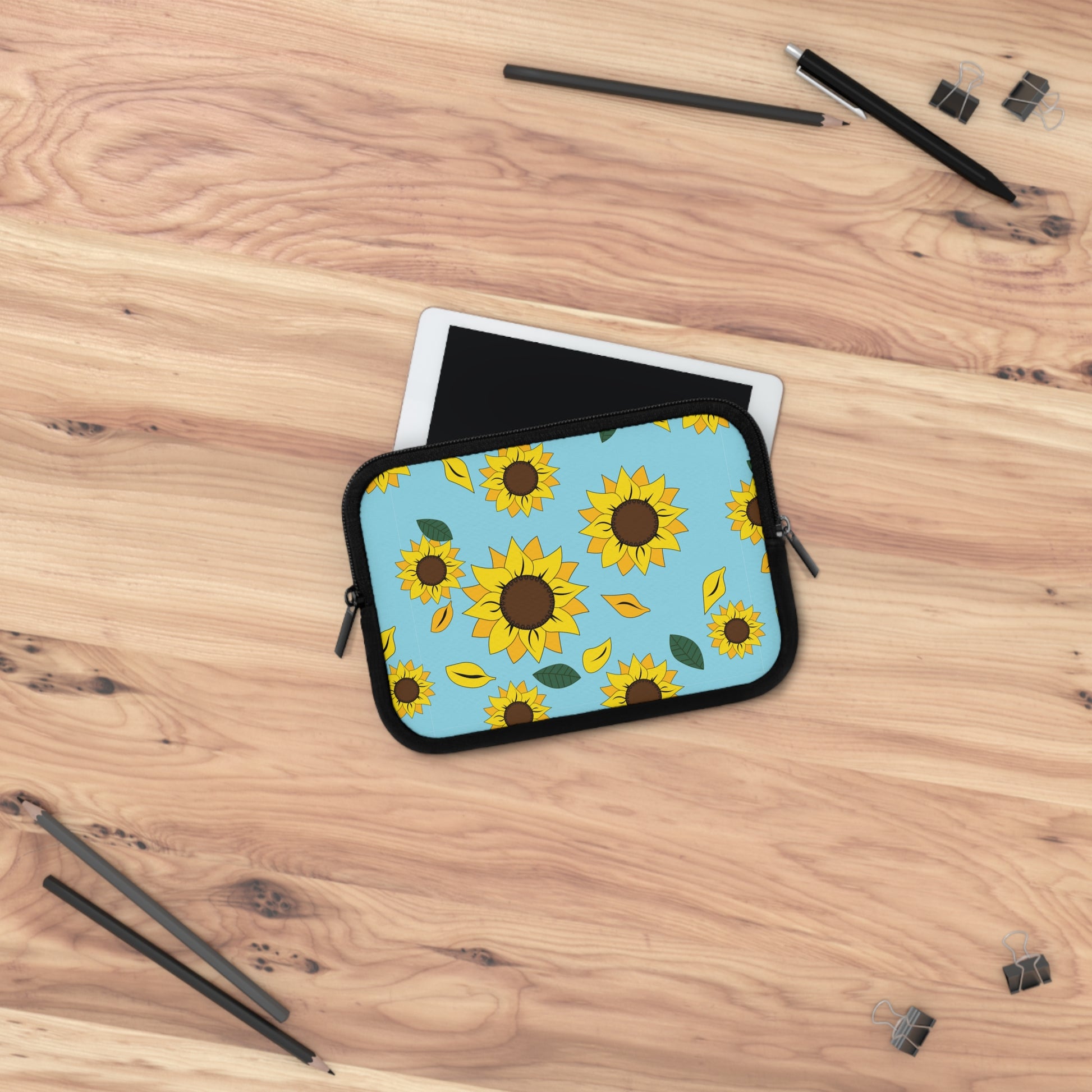 Sunflower patterned iPad sleeve laying over iPad