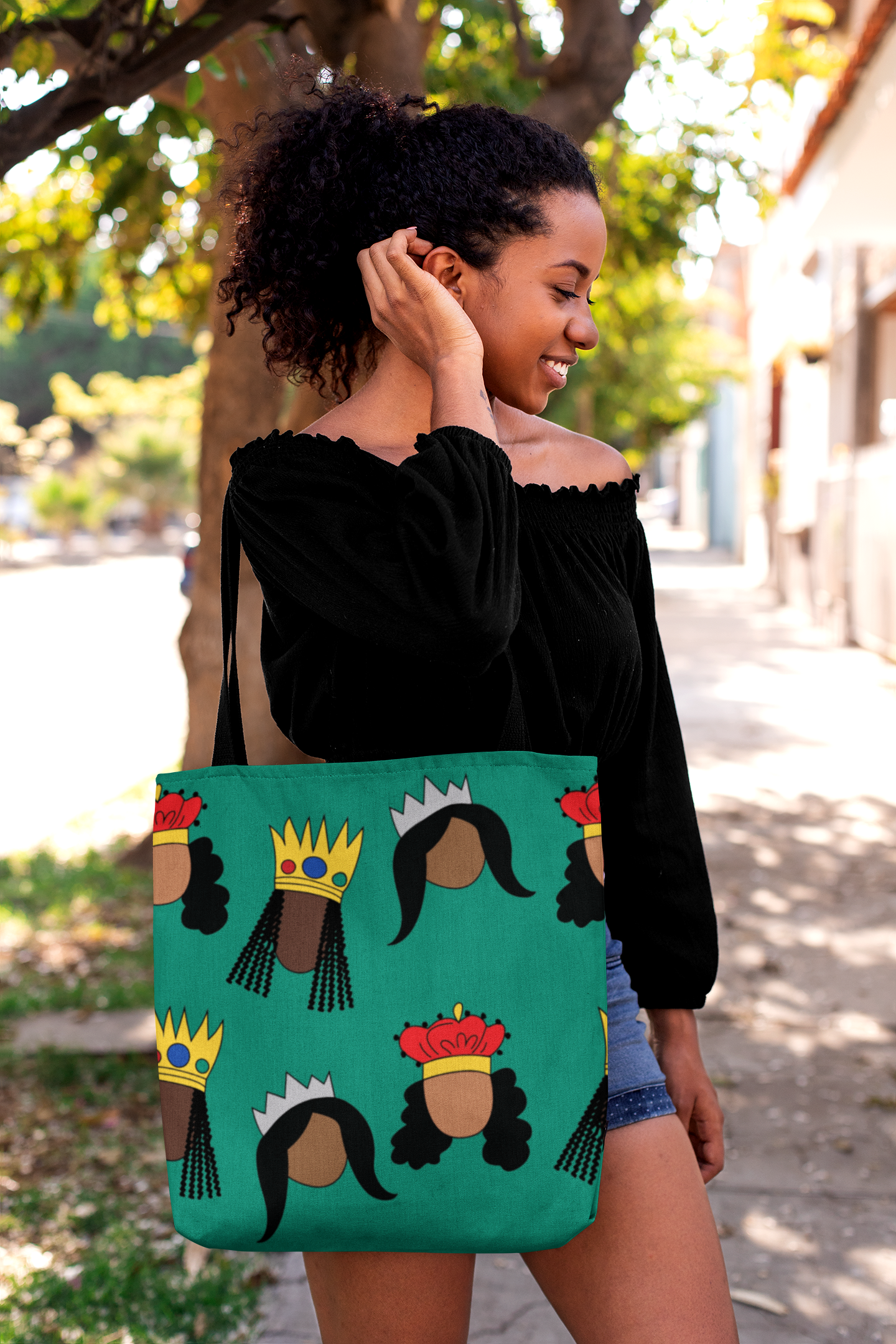 Black woman fixing her hair with Black Queens big print Tote Bag